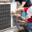 Installer working on air conditioner | Canada HVAC